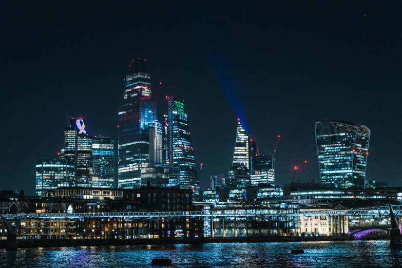 the city skyline is lit up at night, pexels contest winner, london architecture, projection mapping, 2 0 2 2 photo, high detailed photo