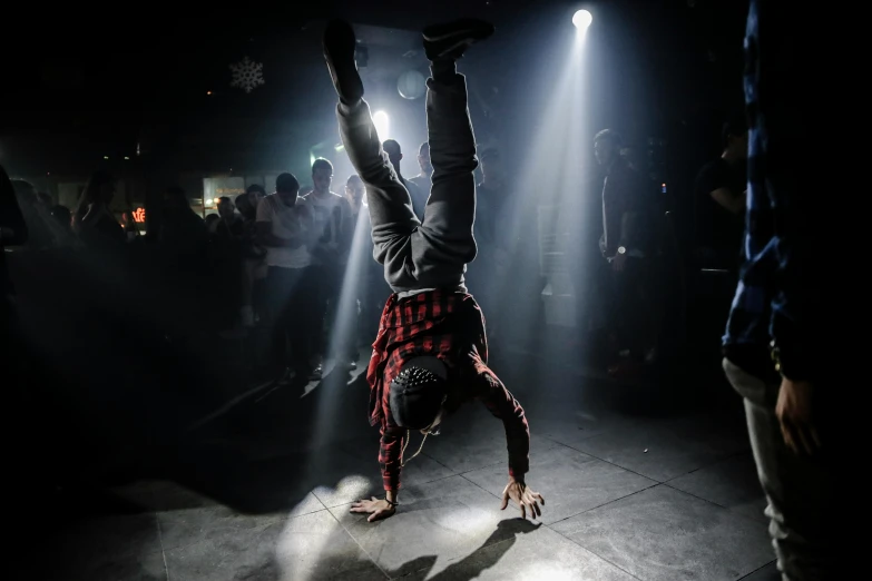 a man doing a handstand in front of a crowd, happening, dancefloor, grime, profile image, high lights