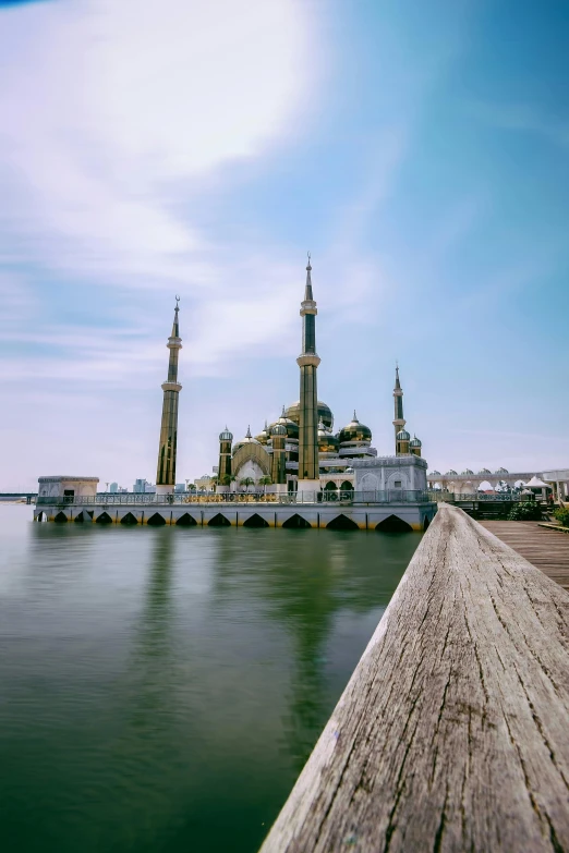 a large building sitting next to a body of water, by Basuki Abdullah, mosque, golden pillars, seaview, boardwalk