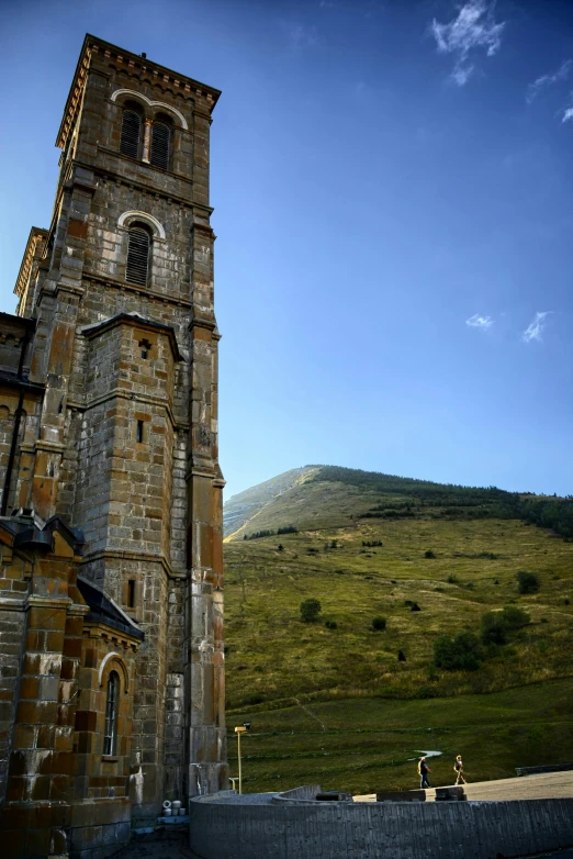 a tall tower sitting on top of a lush green hillside, romanesque, slide show, monumental mountains, churches, exterior shot