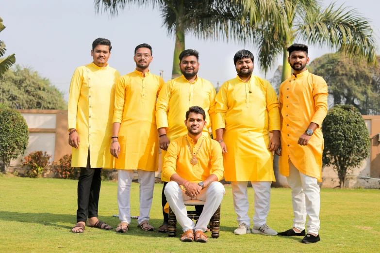 a group of men standing on top of a lush green field, cg society, samikshavad, colors: yellow, profile picture, choir, lookbook