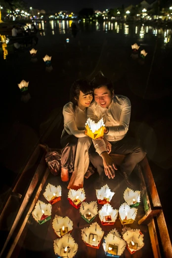 a couple of people sitting on top of a boat, by Jason Felix, chinese lanterns, close up portrait shot, mai anh tran, candlelit catacombs