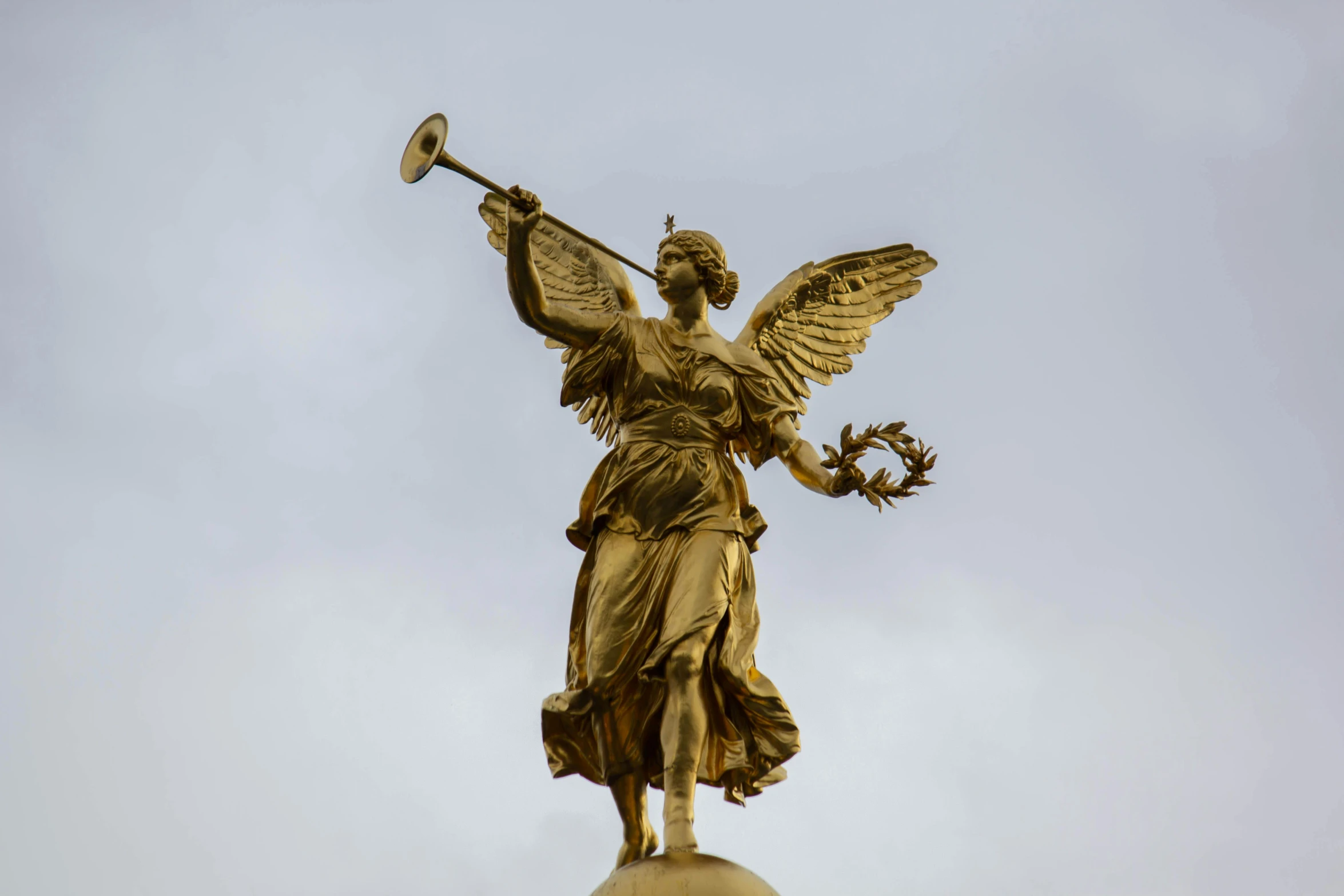 a statue of an angel on top of a building, pexels contest winner, art nouveau, brass instruments, wearing a golden halo, the blind liberty of the few, spanish