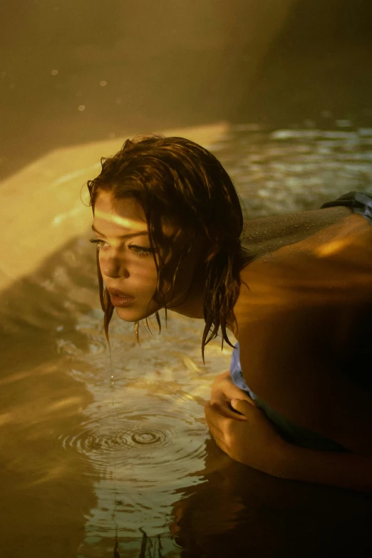 a woman laying on a surfboard in a body of water, inspired by Elsa Bleda, renaissance, portrait of zendaya, soaking wet hair, movie scene close up, shot with sony alpha 1 camera
