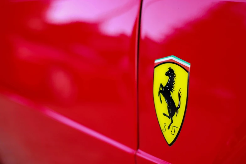 a ferrari badge on the side of a red car, inspired by Bernardo Cavallino, pexels contest winner, renaissance, some red and purple and yellow, icon style, formula 1, taken with sony alpha 9