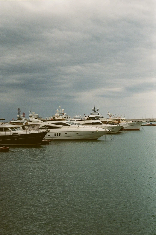 a number of boats in a body of water, on a yacht at sea, film color photography, shipping docks, early 2 0 0 0 s