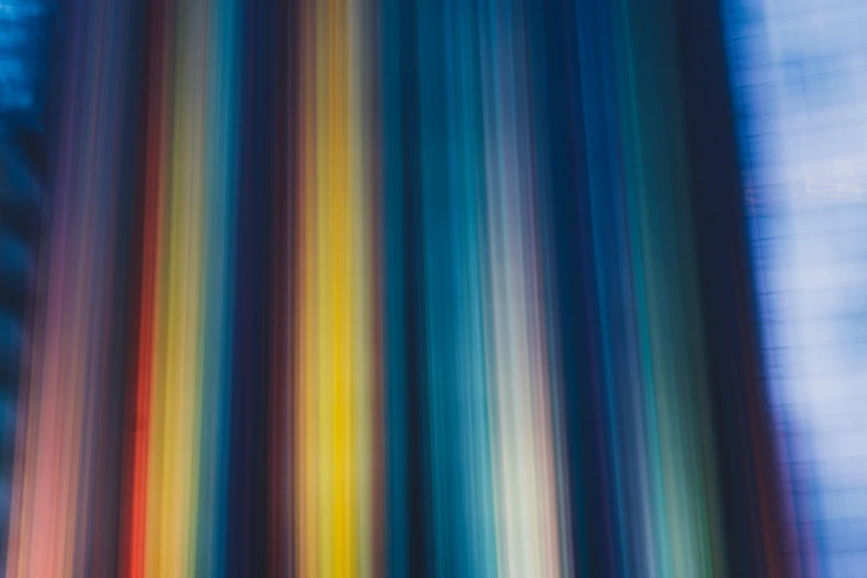 a blurry photo of a multicolored curtain, inspired by Richter, unsplash, blue and yellow lighting, color ( sony a 7 r iv, long exposure, indigo rainbow