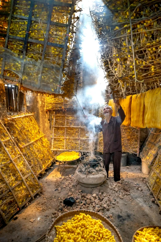 a man standing in a room filled with lots of bananas, inspired by Steve McCurry, pexels contest winner, process art, iron smelting pits, yellow seaweed, iran, incense