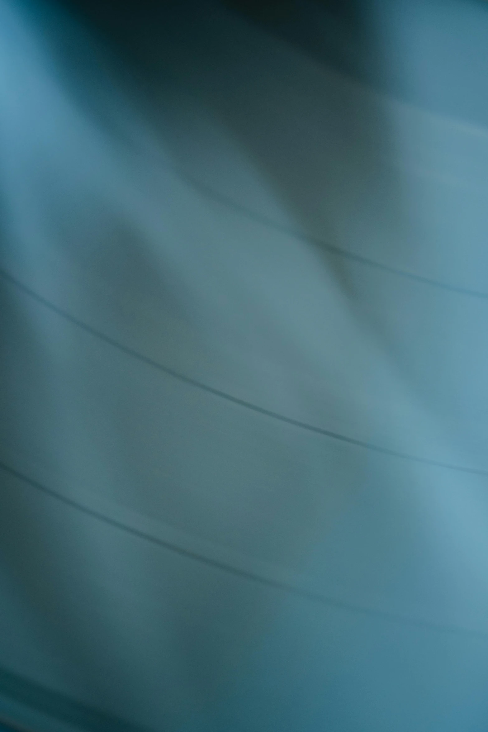 a blurry photo of a person riding a skateboard, an abstract drawing, inspired by Cleve Gray, unsplash, lyrical abstraction, winter blue drapery, cable wires, minimal canon 5 0 mm, high resolution macro photo