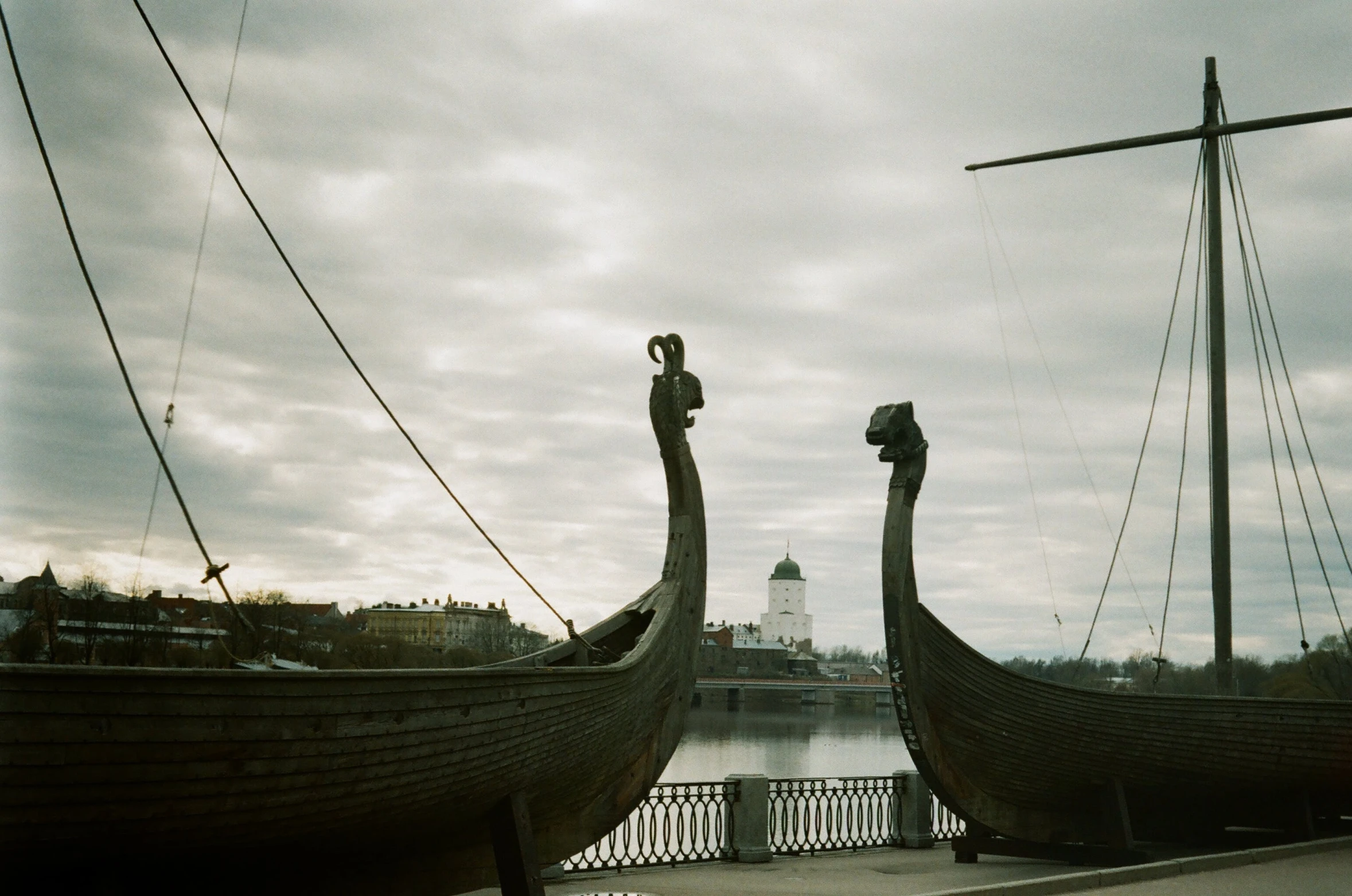 a couple of boats sitting on top of a body of water, inspired by Þórarinn B. Þorláksson, unsplash contest winner, hurufiyya, ancient russian architecture, analogue photo quality, photo taken on fujifilm superia, sculptures