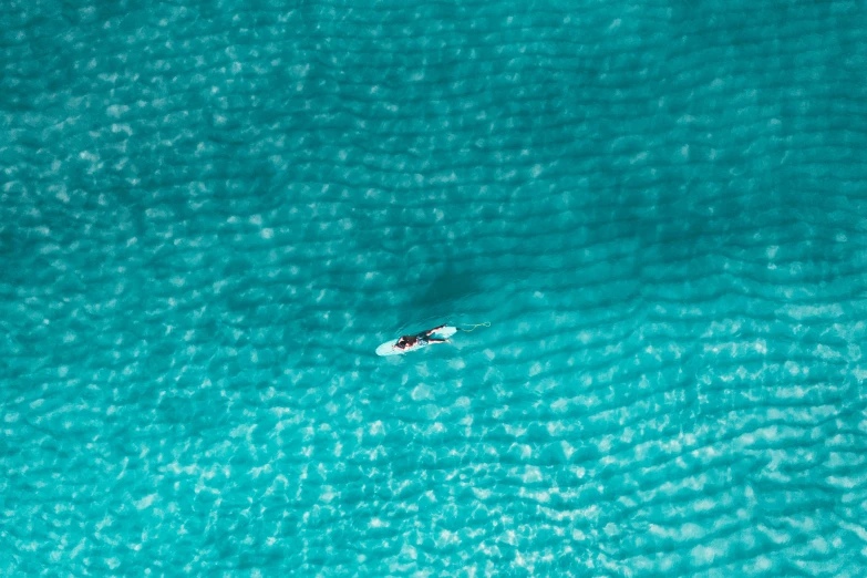 a person on a surfboard in the middle of the ocean, by Matthias Weischer, pexels contest winner, minimalism, turquoise water, birdseye view, cornwall, thumbnail