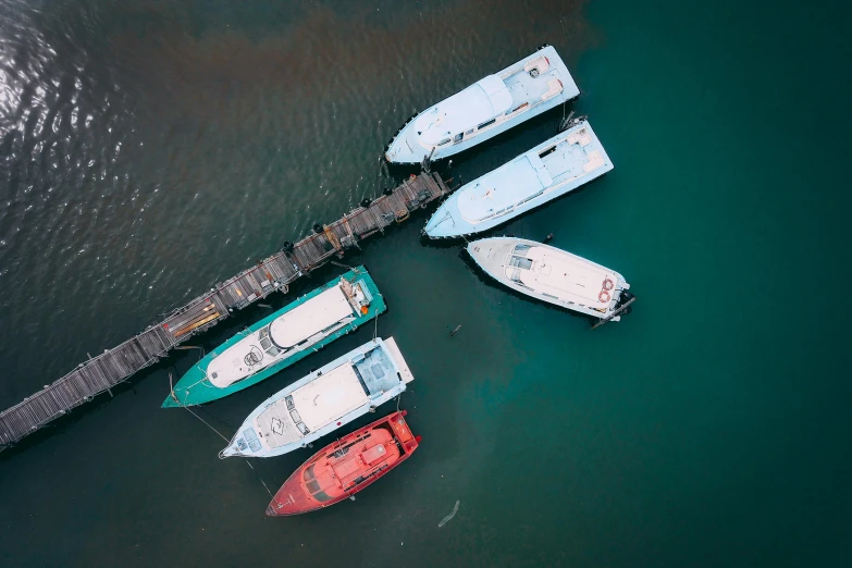 a group of boats sitting on top of a body of water, a screenshot, pexels contest winner, birds eye, fan favorite, striking colour, terminals