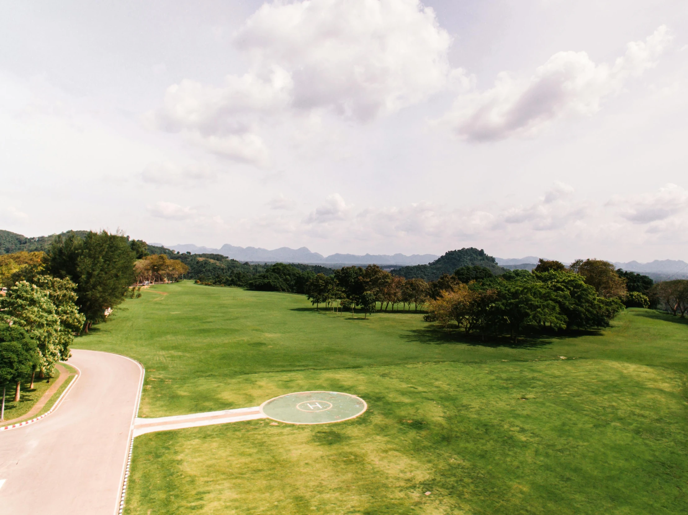 a bird's eye view of a golf course, an album cover, pexels contest winner, realism, sangyeob park, wide long view, sri lanka, helipad