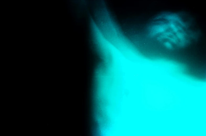 a man that is standing up in the dark, a hologram, inspired by Elsa Bleda, unsplash, happening, floating. greenish blue, belly exposed, made of glowing wax, close-up photograph