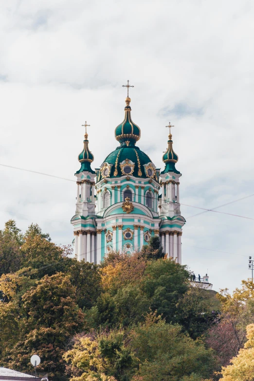 a church sitting on top of a lush green hillside, baroque, neo kyiv, turquoise gold details, a middle-shot from front, square