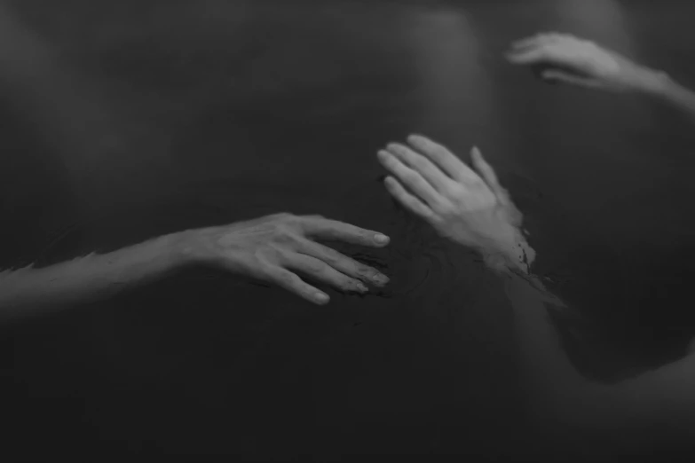 two hands reaching towards each other in black and white, a black and white photo, by Emma Andijewska, conceptual art, people swimming, dark aesthetic, murder, flume cover art