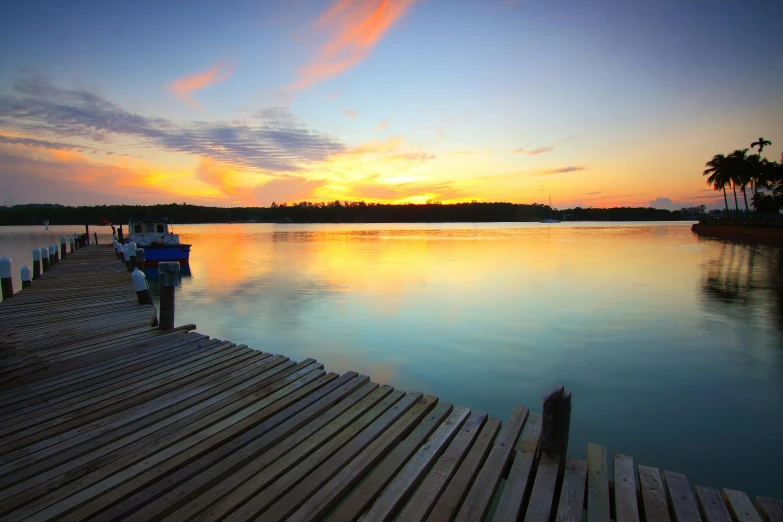 a dock next to a body of water at sunset, hurufiyya, multicoloured, a wooden, best photo, lake blue