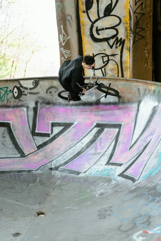 a man riding a skateboard up the side of a ramp, a picture, graffiti, circle pit, slide show, bowl, arcs