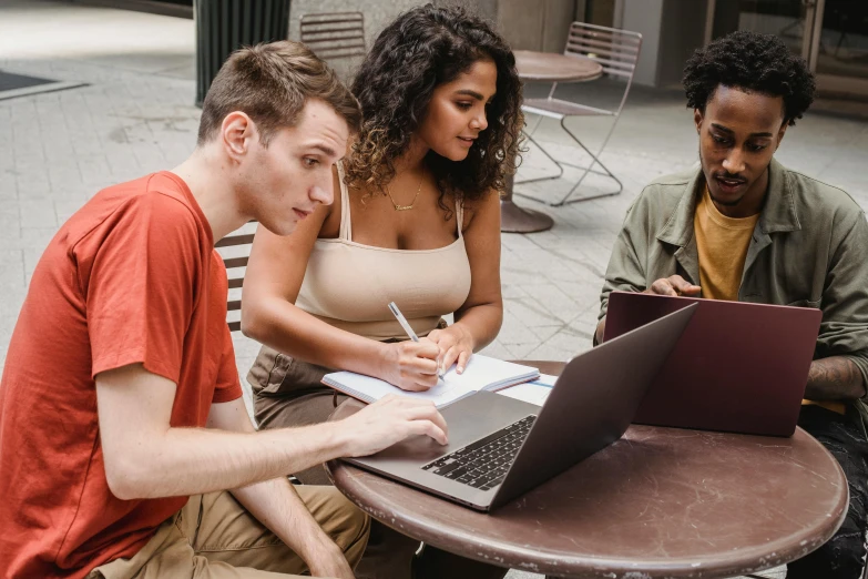 a group of people sitting around a table with laptops, pexels contest winner, at college, alana fletcher, thumbnail, background image