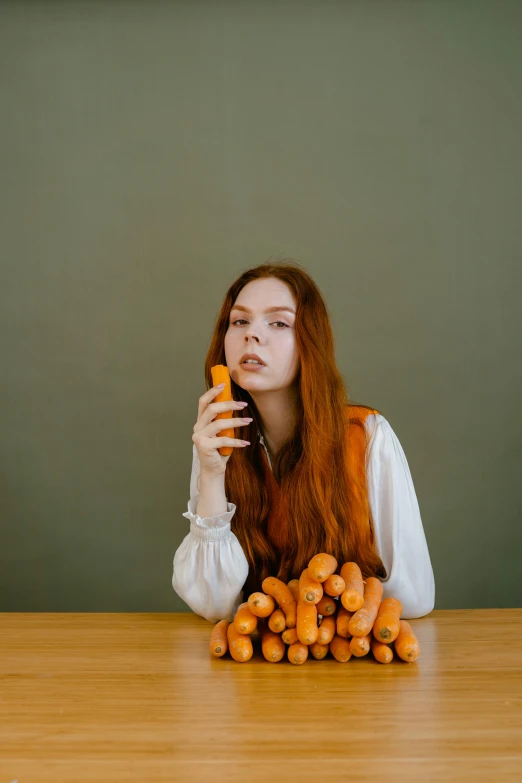 a woman sitting at a table with a bunch of carrots, inspired by Elsa Bleda, unsplash, realism, long ginger hair, hot dog, high quality photo, thoughtful )