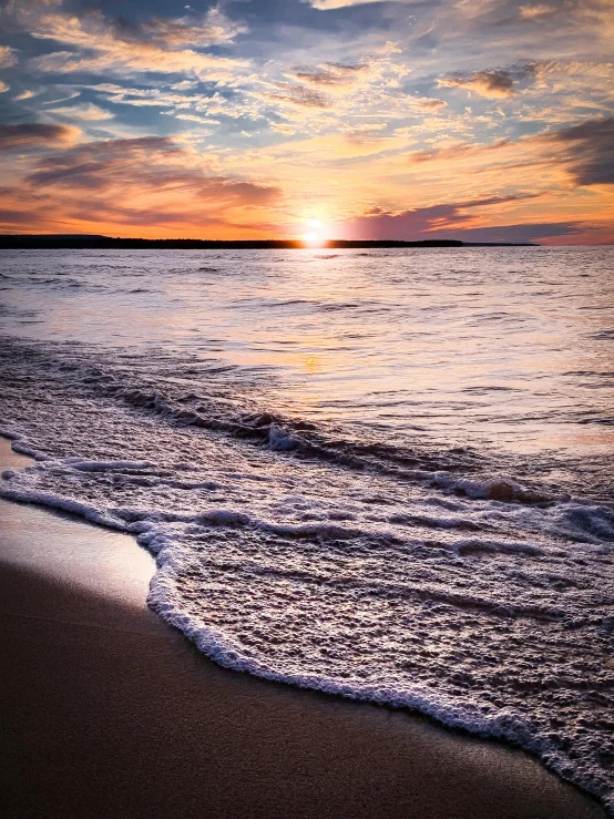 the sun is setting over the water on the beach, by Greg Rutkowski, pexels contest winner, calm waves, orkney islands, slide show, closeup!!!!!!