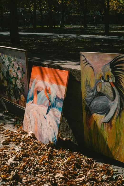 a row of paintings sitting on the side of a road, by Zofia Stryjenska, trending on pexels, zoo, classical art, art stand, charts