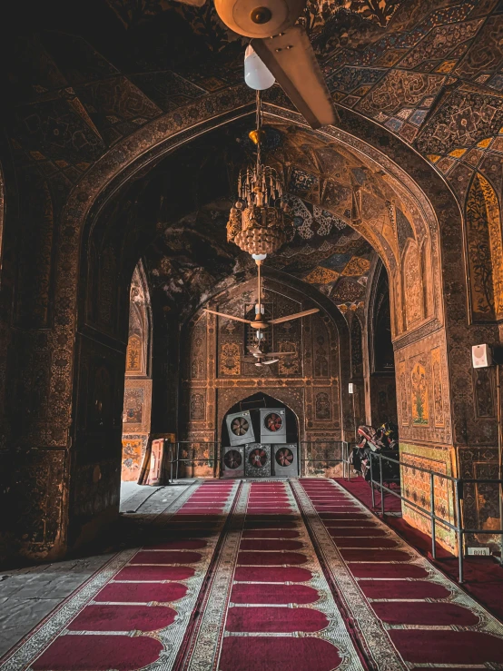 a room with a red carpet and a chandelier, unsplash contest winner, qajar art, in a temple, ( ( theatrical ) ), cairo, more intense