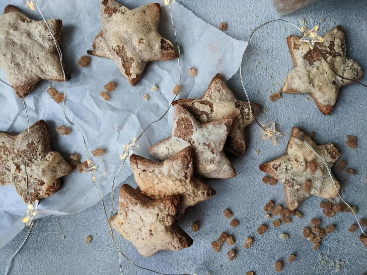 a bunch of cookies sitting on top of a table, by Sylvia Wishart, pexels, baroque, falling stars, muted browns, animal - shaped bread, instagram post