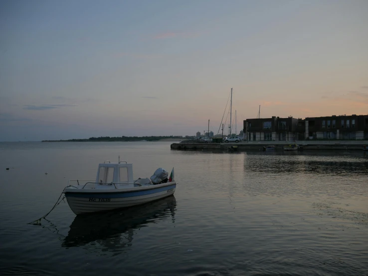 a small boat sitting on top of a body of water, a picture, evening time, taken from the high street, med bay, grey