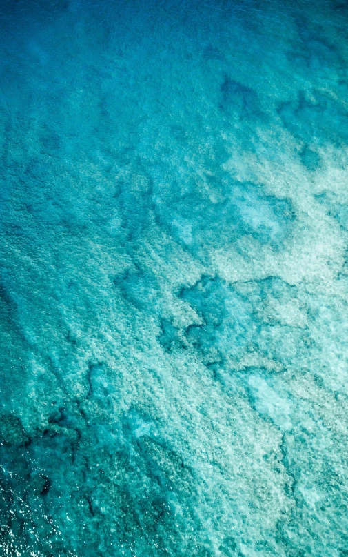 an aerial view of a large body of water, a microscopic photo, pexels, bubbly underwater scenery, slightly pixelated, wall of water either side, battered