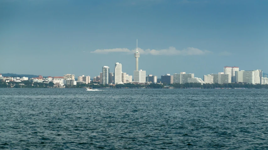 a large body of water with a city in the background, pexels contest winner, hurufiyya, sub tropical, 200mm wide shot, sarenrae, high quality image”