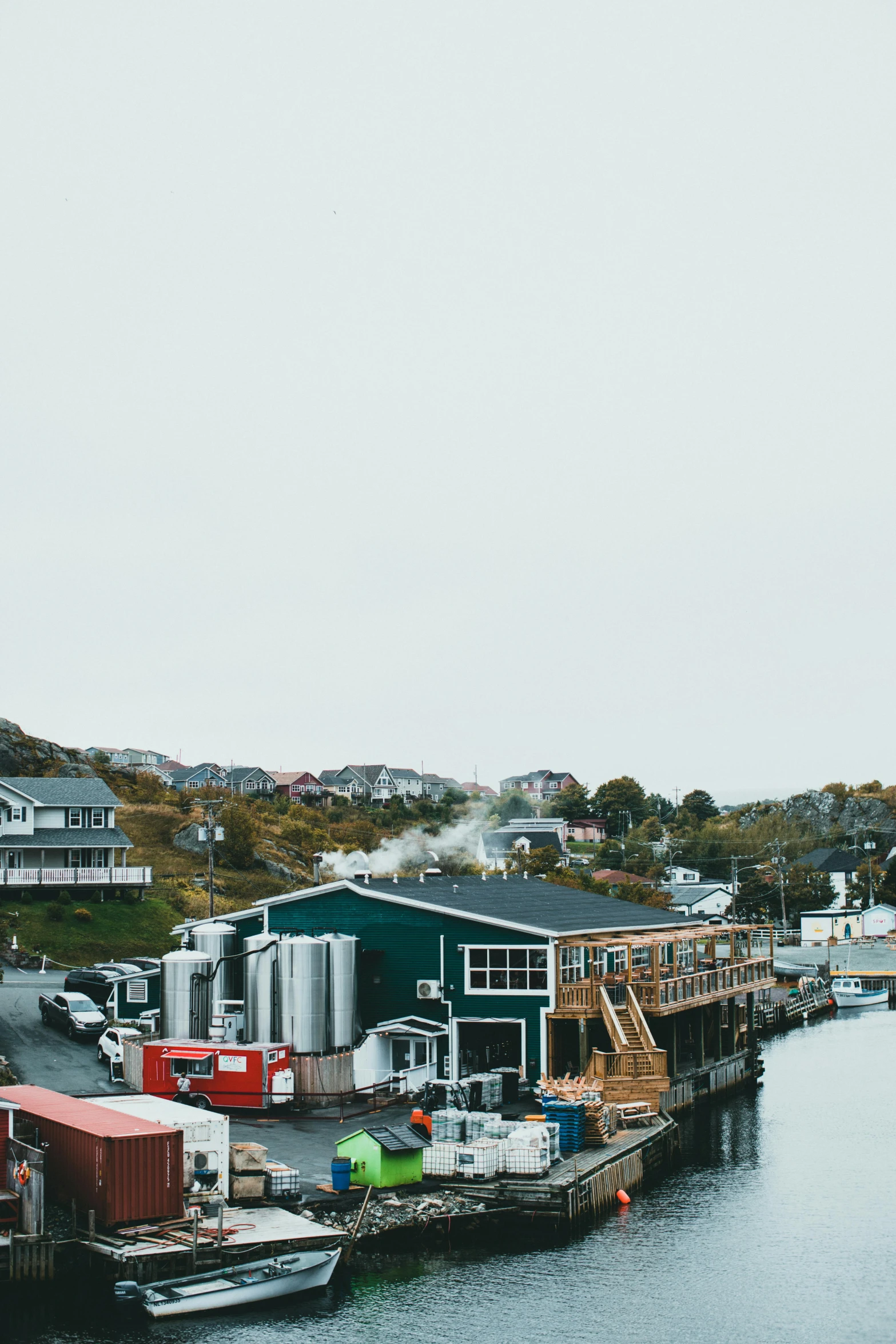 a number of boats in a body of water, by Jessie Algie, pexels contest winner, small buildings, beer, canada, low quality photo