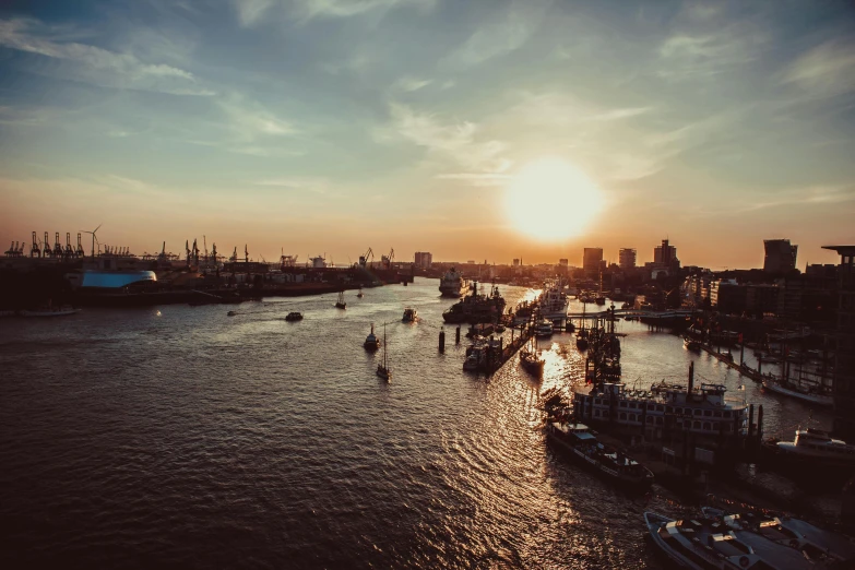 a large body of water filled with lots of boats, by Tobias Stimmer, pexels contest winner, city sunset, scenic view of river, grainy quality, thumbnail