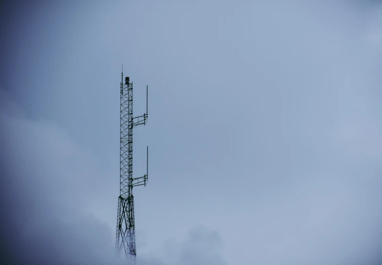 a tall tower sitting in the middle of a cloudy sky, unsplash, minimalism, radio equipment, square, blue, low quality photo