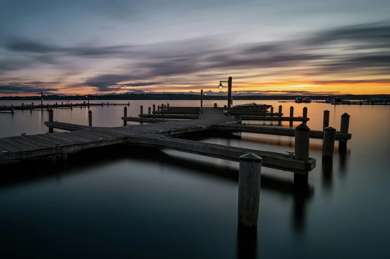 a dock in the middle of a body of water, by Peter Churcher, pexels contest winner, dusk light, manly, inlets, 8k resolution”