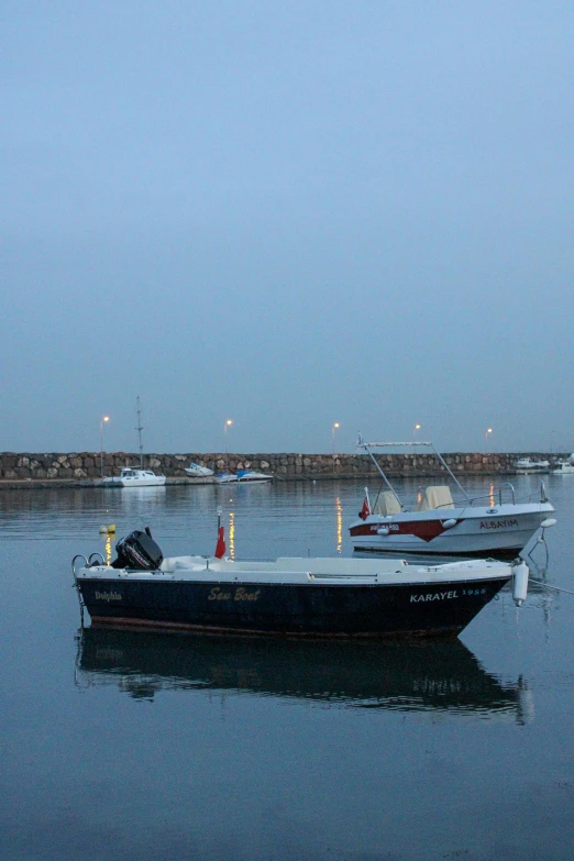 a couple of boats that are in the water, les nabis, before dawn, slight overcast weather, harbour, around 20 yo