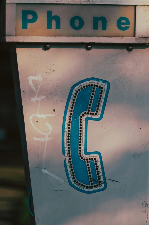 a close up of a phone on a pole, an album cover, by Elsa Bleda, unsplash, graffiti, detailed letters, white and teal metallic accents, film photo from 1970s, corporate phone app icon