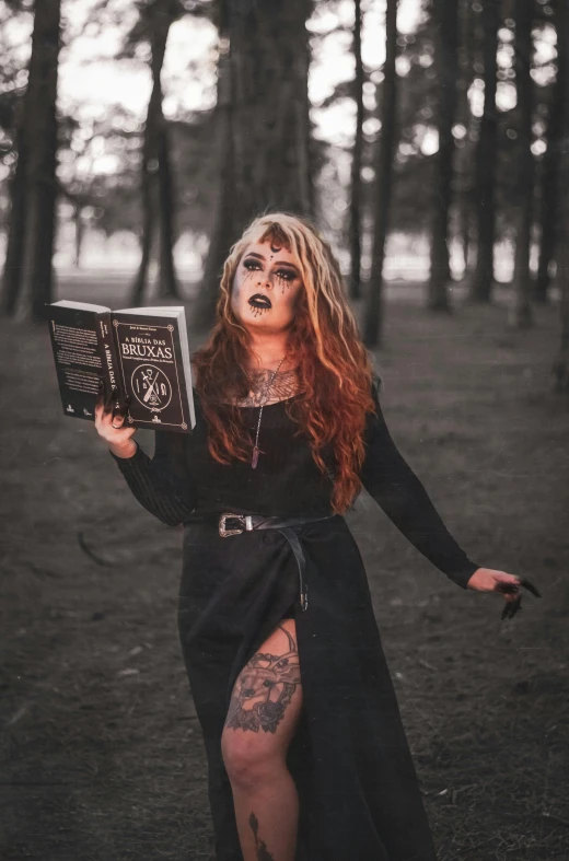 a woman in a black dress holding a book, an album cover, pexels contest winner, gothic art, wearing apocalyptic clothes, low quality photo, halloween, gothic tattoos