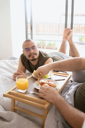 a couple of men sitting on top of a bed, trending on reddit, hearty breakfast, man with glasses, full frame image, medium shot angle