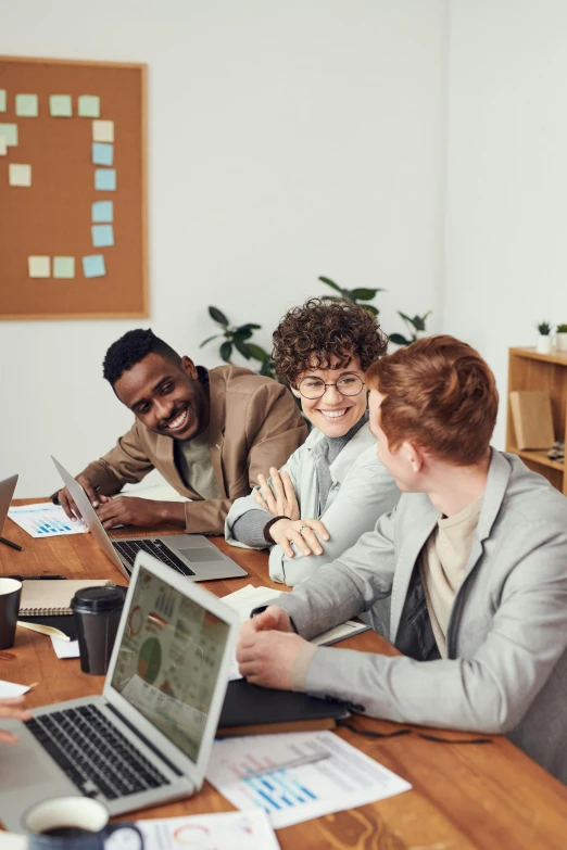 a group of people sitting around a table with laptops, trending on pexels, renaissance, hr ginger, smiling at each other, thumbnail, lgbtq