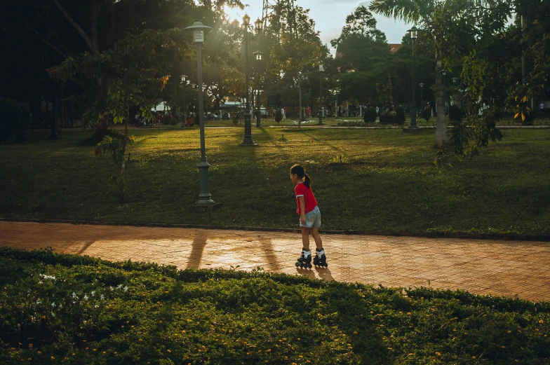 a little girl riding a skateboard down a sidewalk, by Julia Pishtar, unsplash contest winner, futuristic phnom-penh cambodia, sunny day in a park, evening at dusk, parks and gardens