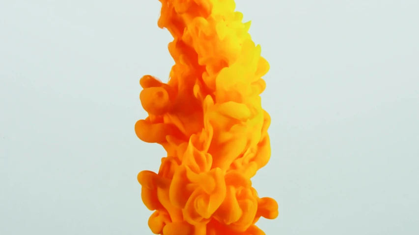 a close up of a yellow candle on a table, an abstract sculpture, inspired by Lynda Benglis, zbrush central, conceptual art, colored smoke clouds, orange spike aura in motion, sofubi, detailed product shot