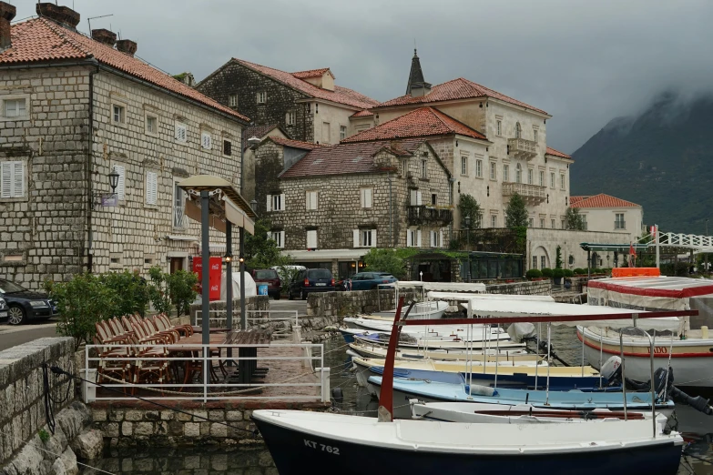 a couple of boats that are sitting in the water, by Emma Andijewska, pexels contest winner, renaissance, small port village, boka, overcast skies, square