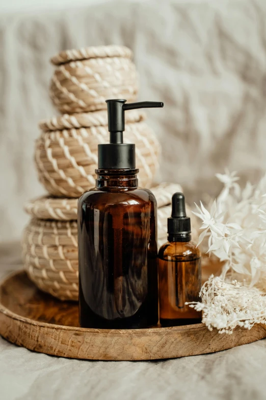 a couple of bottles sitting on top of a wooden tray, a portrait, unsplash, renaissance, skincare, brown resin, 1 6 x 1 6, thumbnail