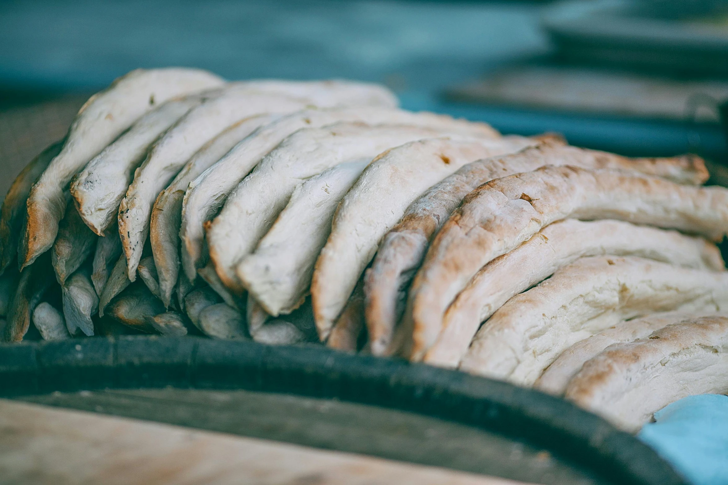 a bunch of bread sitting on top of a cutting board, by Emma Andijewska, unsplash, pork meat, raku, magnificent oval face, silver platter