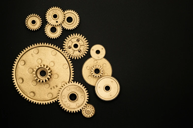 a bunch of gears on a black surface, pexels contest winner, assemblage, golden organic structures, minimal shading, ilustration, gold metal
