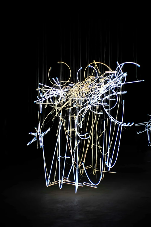 a group of people that are standing in the dark, an abstract sculpture, by Cerith Wyn Evans, kinetic art, intricate white and gold neon, tangled cables, hyperrealistic ”, wisps of energy in the air