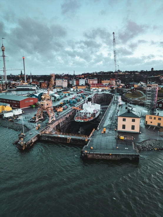 a harbor filled with lots of boats under a cloudy sky, by Tom Wänerstrand, pexels contest winner, stockholm city portrait, drone footage, thumbnail, shipyard