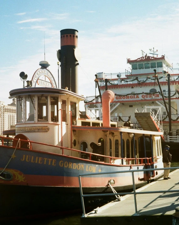 a large boat sitting on top of a body of water, a colorized photo, by Linda Sutton, trending on unsplash, art nouveau, theme park, downtown jacksonville florida, victorian fire ship, taken in the mid 2000s