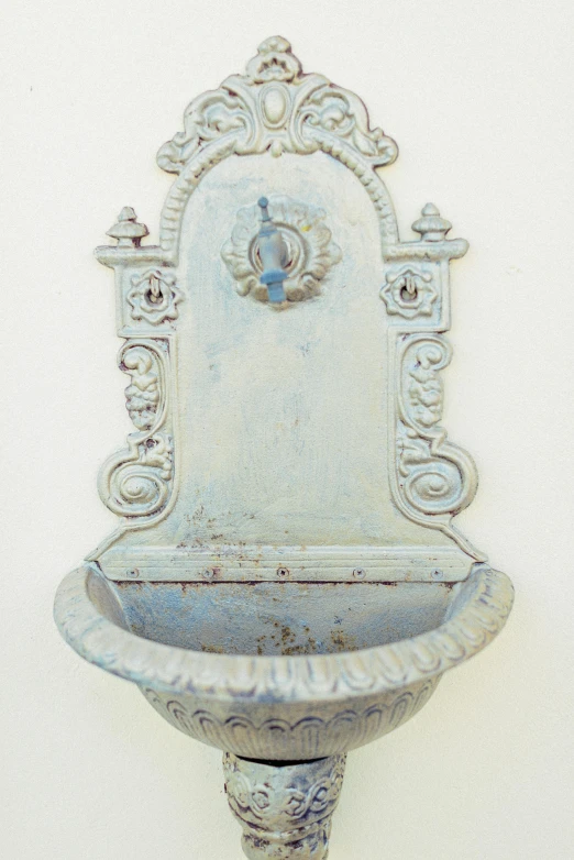 a water fountain mounted to the side of a wall, pinterest, renaissance, pastel blue, early 2 0 th century, white metal, fine texture